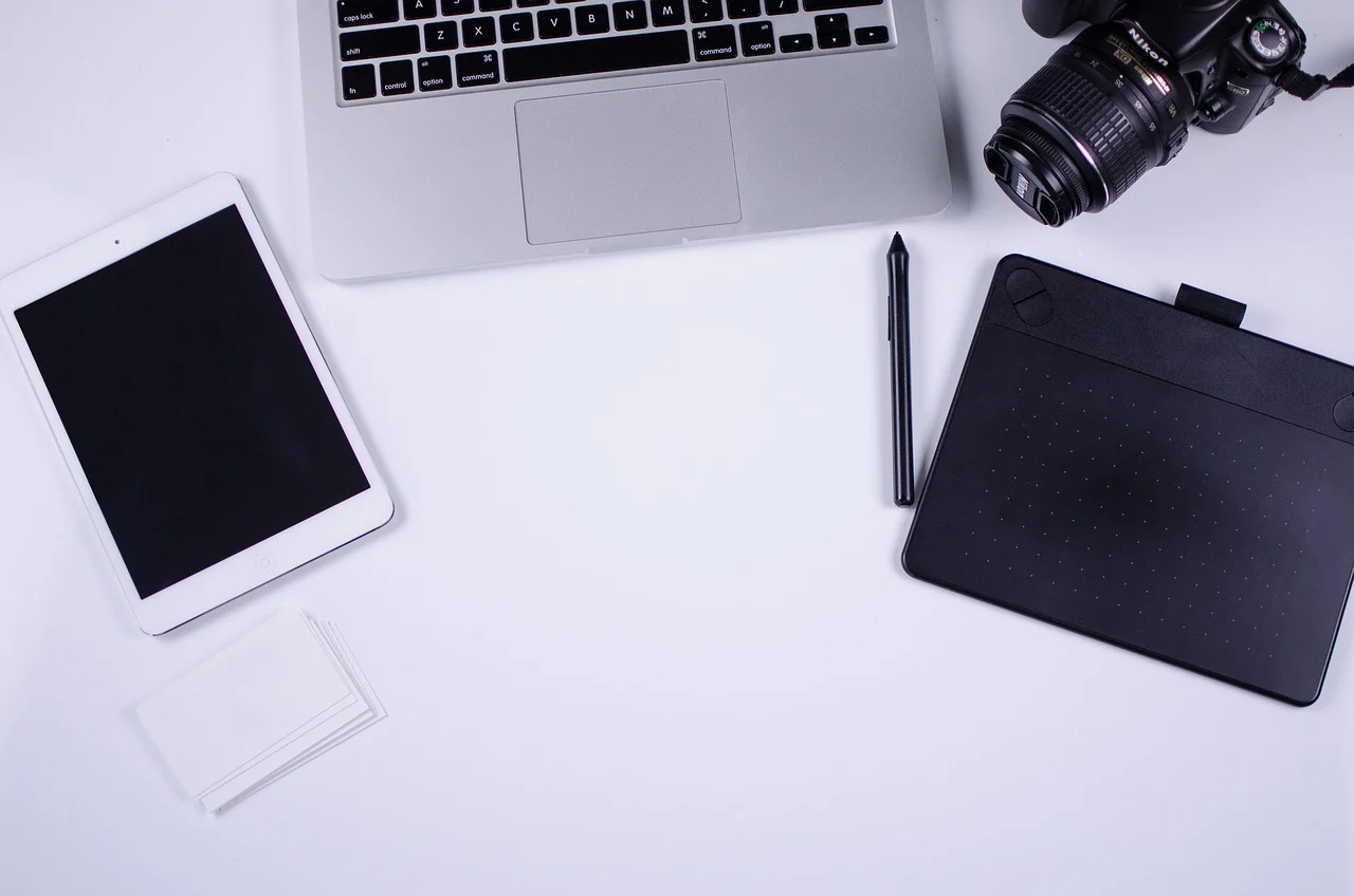 Blogger working on content audit at laptop desk with coffee