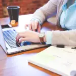 Person working on keyword research on a laptop with graphs and analytics visible