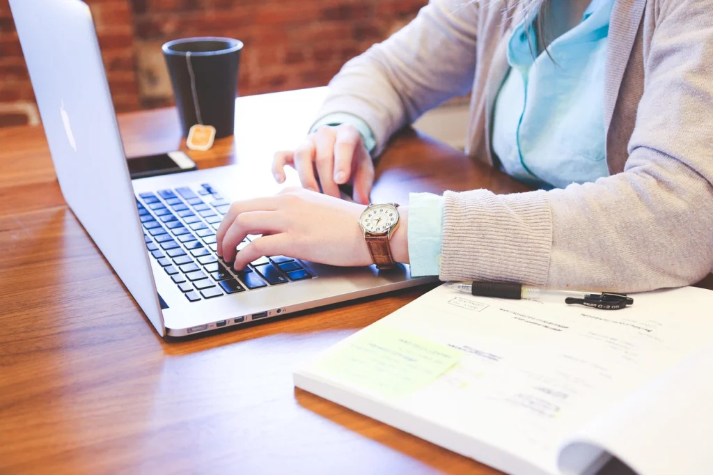 Person working on keyword research on a laptop with graphs and analytics visible