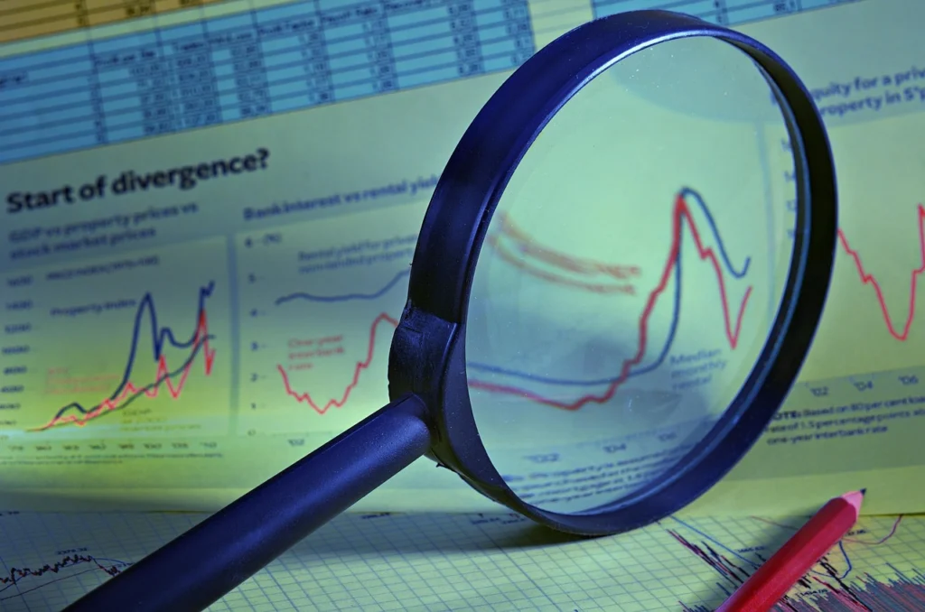 Magnifying glass over charts and data representing market research