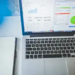 Laptop on a desk showing analytics charts, representing SEO audit vs website audit
